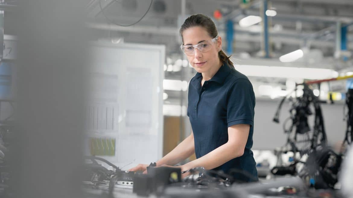 Worker at production line for cable assembling